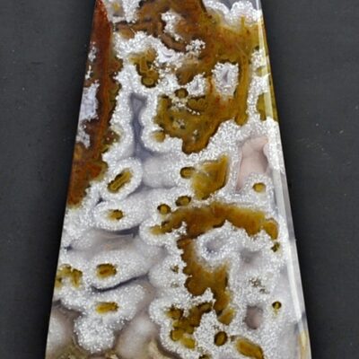 A piece of agate with a white and brown pattern.