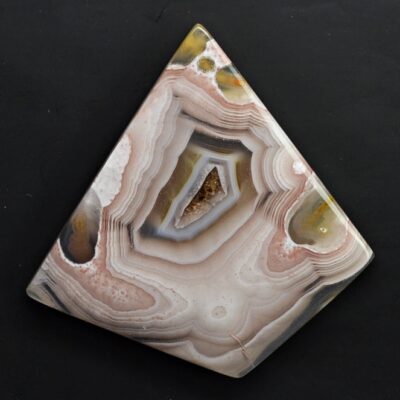 A piece of agate on a black surface.