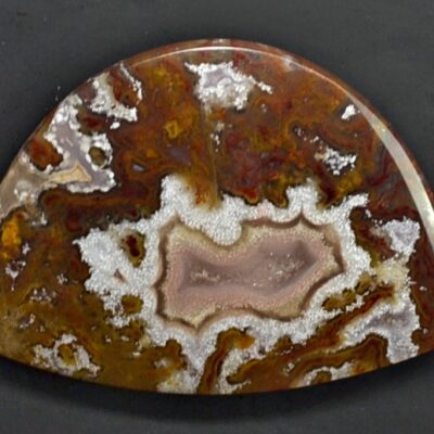 A piece of agate with brown and white spots.