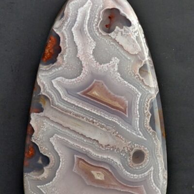 A piece of agate on a black surface.