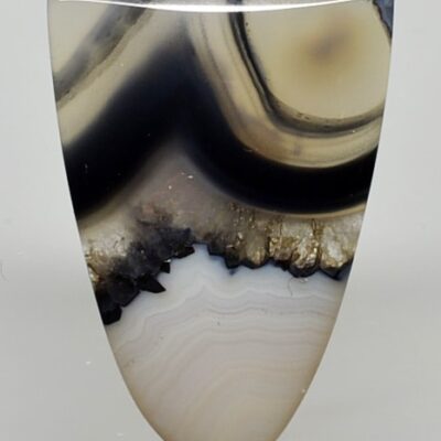 A black and white agate vase on a white surface.