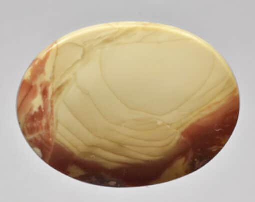 A round piece of yellow and brown marble on a white surface.