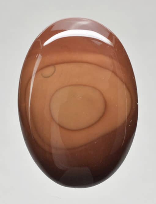 A brown oval agate stone on a white background.