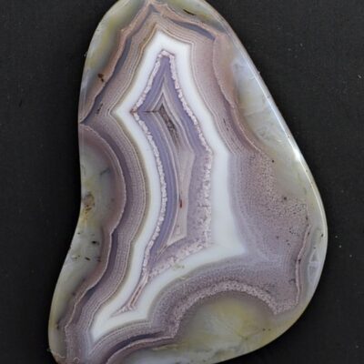 A piece of purple agate on a black surface.