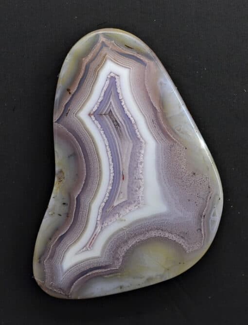 A piece of purple agate on a black surface.