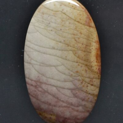A stone with a brown and white pattern on it.