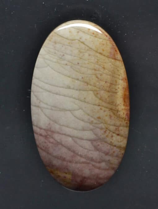 A stone with a brown and white pattern on it.