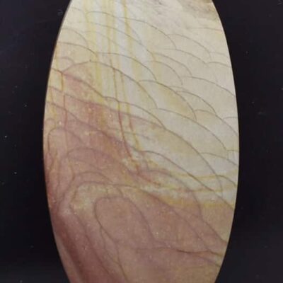 A round piece of wood with a brown and yellow pattern.