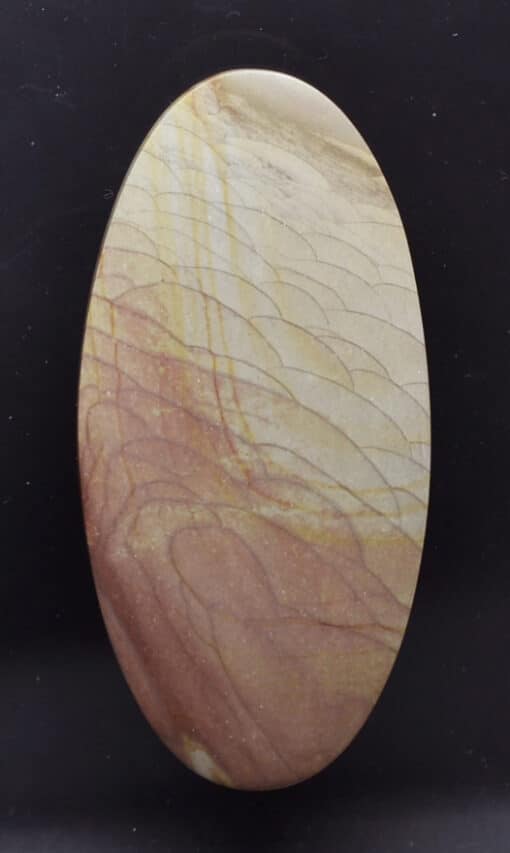 A round piece of wood with a brown and yellow pattern.