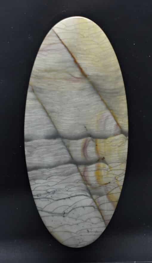 An oval piece of marble with a yellow and white pattern.