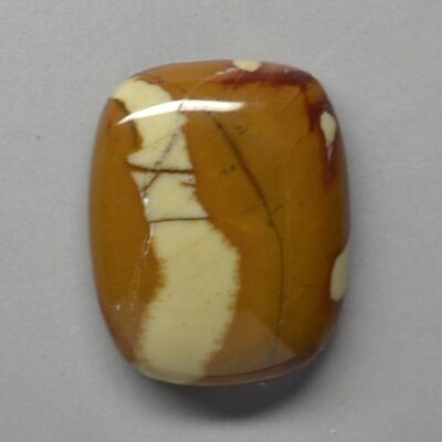 A brown and white stone cabochon.
