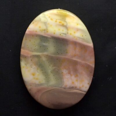 A round piece of yellow, green, and brown agate.