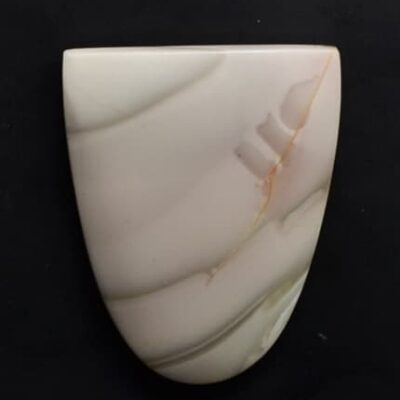 A piece of white agate on a black surface.