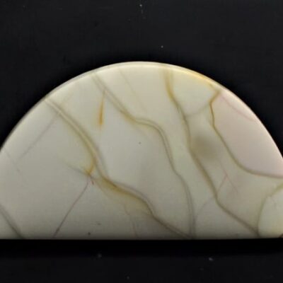 A piece of white marble on a black surface.