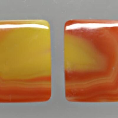 A pair of orange and yellow agate cabochons.