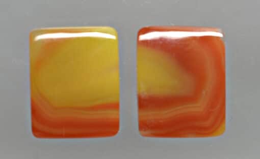 A pair of orange and yellow agate cabochons.