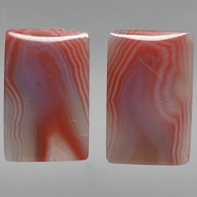 A pair of red and blue agate cabochons.