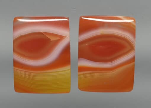 Pair of orange and yellow agate cabochons.