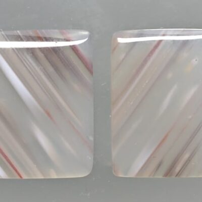 Two pieces of white agate with red stripes.