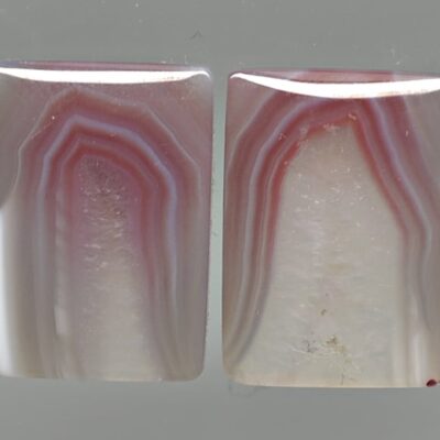 A pair of pink and white agate cabochons.