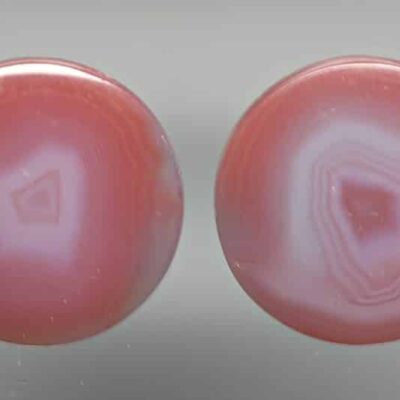 A pair of pink agate cabochons.