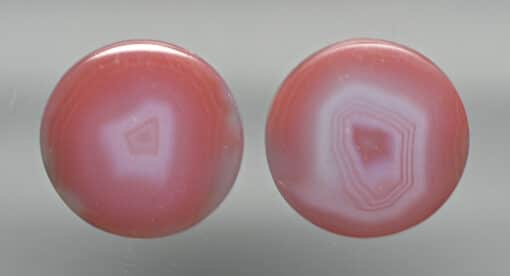A pair of pink agate cabochons.
