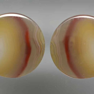 A pair of yellow and orange agate stud earrings.
