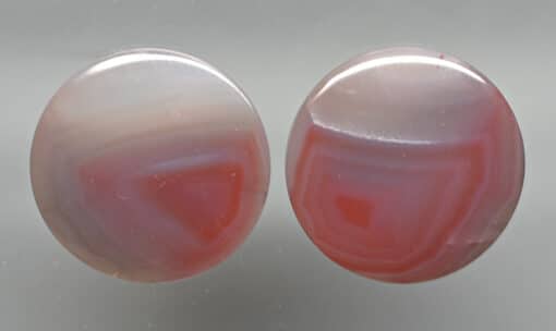 A pair of pink and white agate stud earrings.