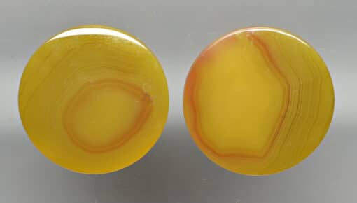 A pair of yellow agate oval cabochons.