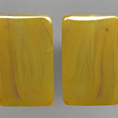 A pair of yellow jade cabochons.