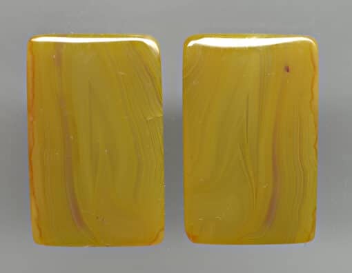 A pair of yellow jade cabochons.