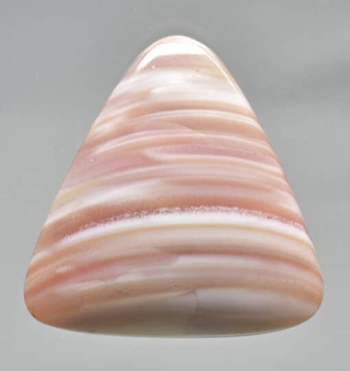 A pink and white triangle shaped cabochon.