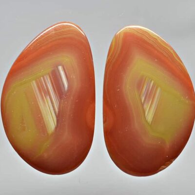 A pair of orange and yellow agate earrings.