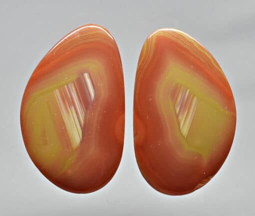 A pair of orange and yellow agate earrings.