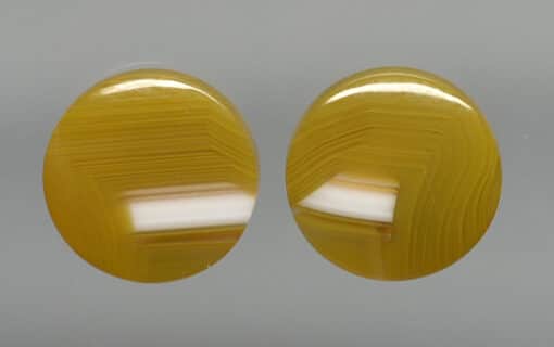 Pair of yellow agate oval cabochons.