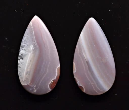 A pair of pink and white agate tear shaped cabochons.