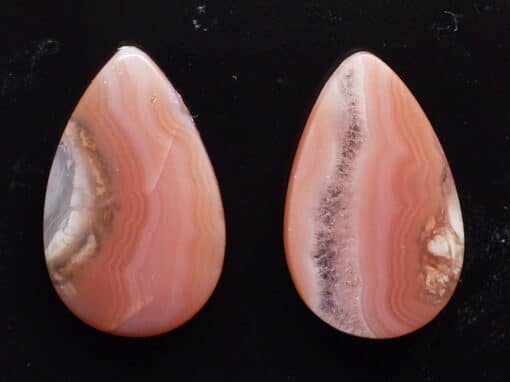 A pair of pink agate tear shaped cabochons.