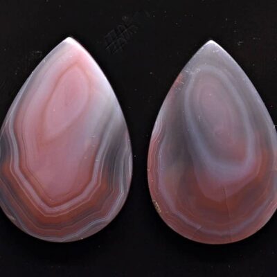 A pair of pink agate tear shaped cabochons.