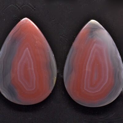 A pair of red and white agate tear shaped cabochons.