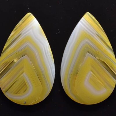 Two yellow and white agate tear shaped cabochons.