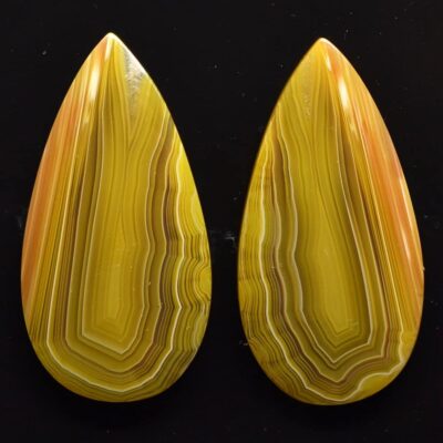 A pair of yellow agate tear shaped cabochons.