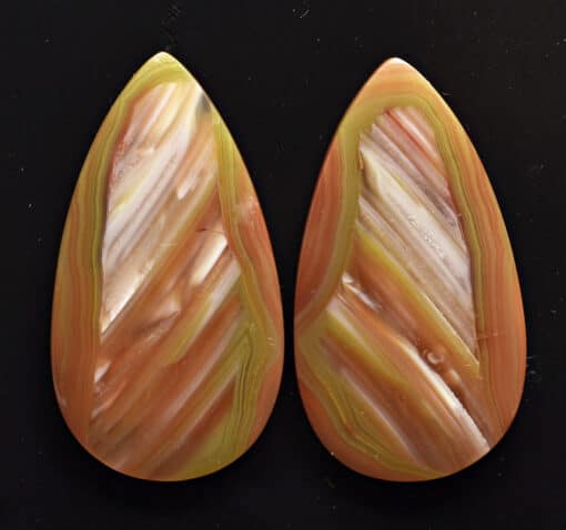 A pair of orange and yellow tear shaped cabochons.