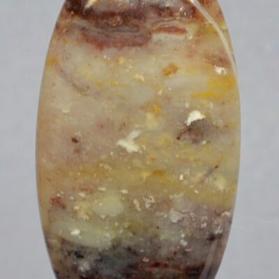 An oval agate stone with a yellow and brown color.