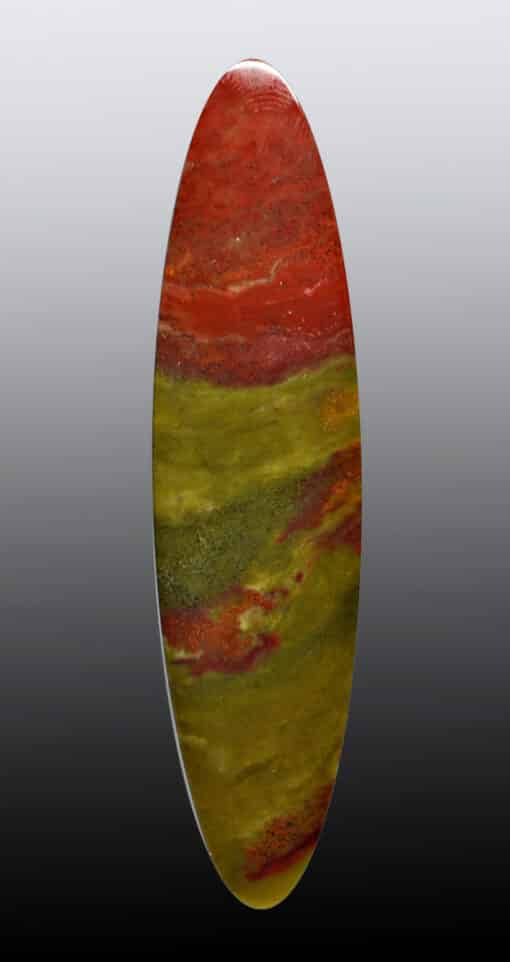 A red, yellow and green marble oval on a black background.