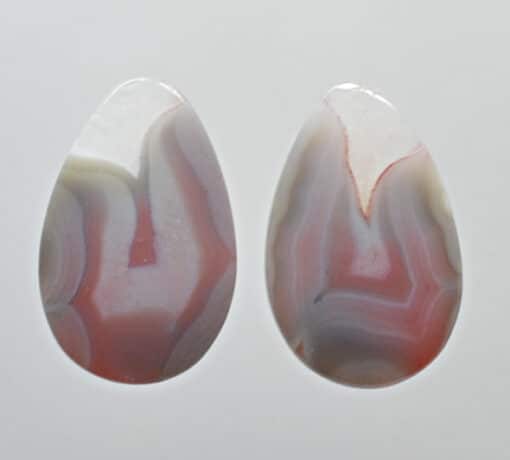 A pair of red and white agate tear shaped cabochons.