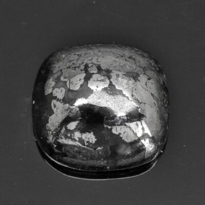 An image of a black diamond on a black surface.