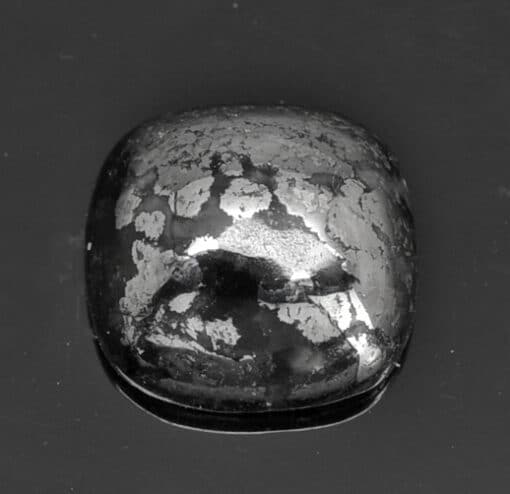 An image of a black diamond on a black surface.