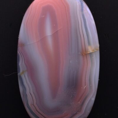 A pink and purple agate oval cabochon.
