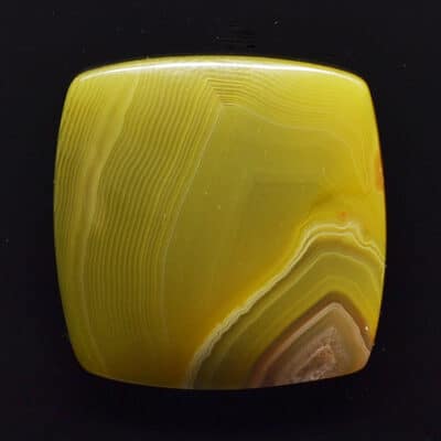 A yellow agate pendant on a black background.