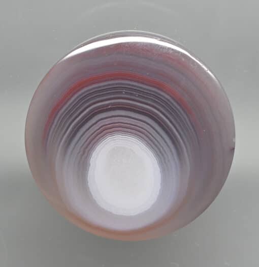 A piece of agate with a red and white pattern.